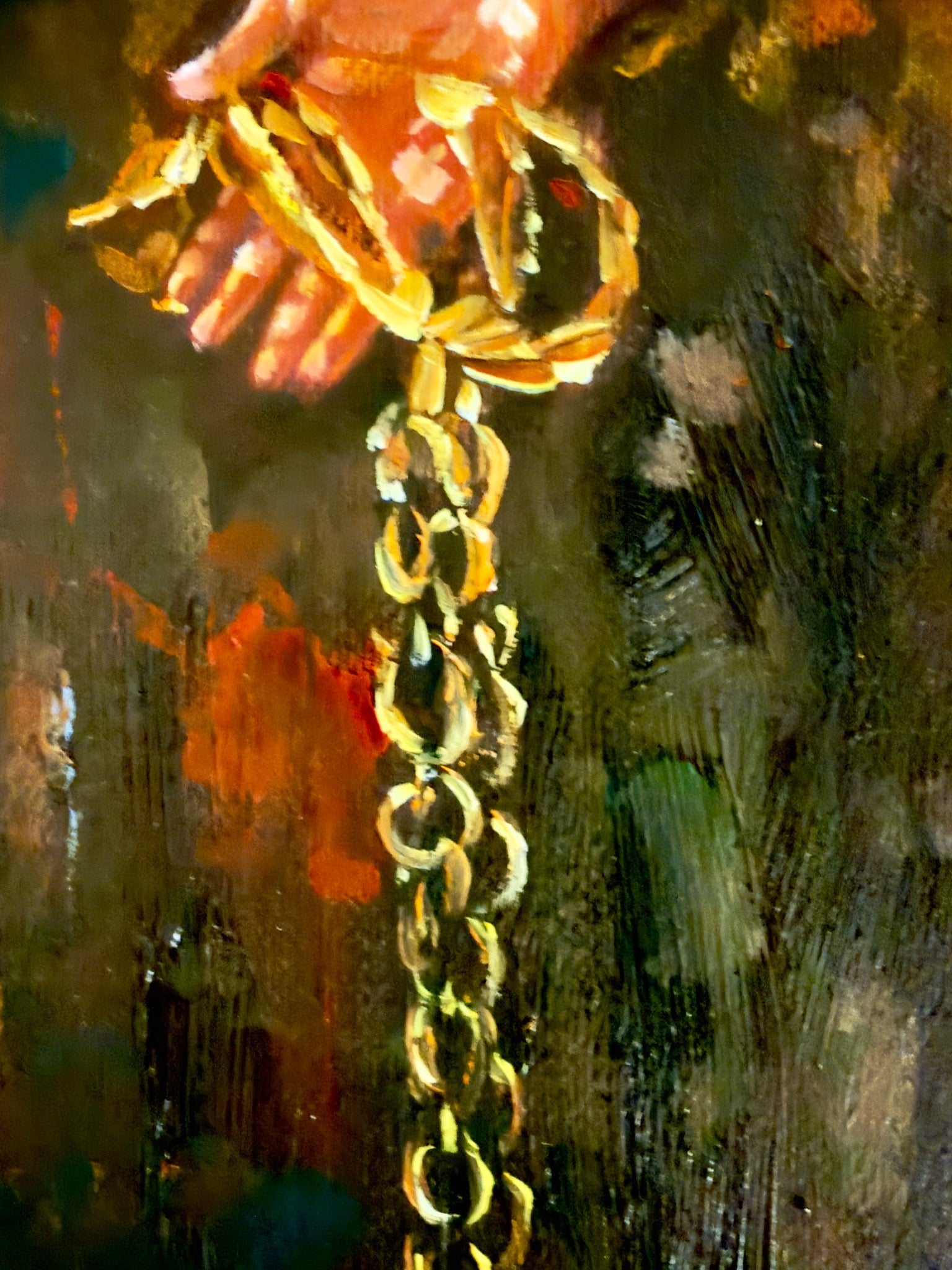 Detailed photograph of the open hand and heavy golden chain links in Ascension