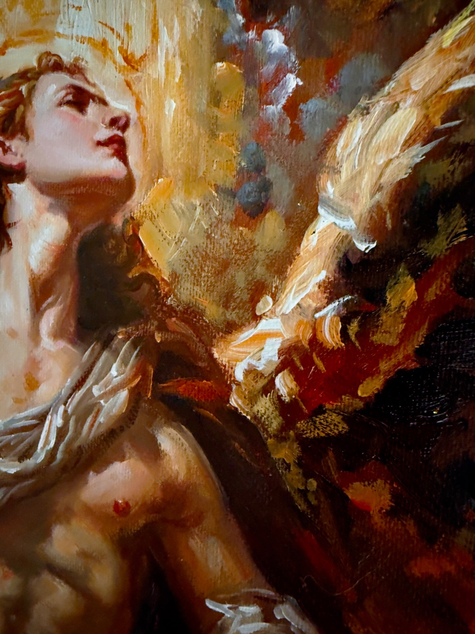 Close-up of the winged man’s upturned face, shoulder and textured wing in Ascension